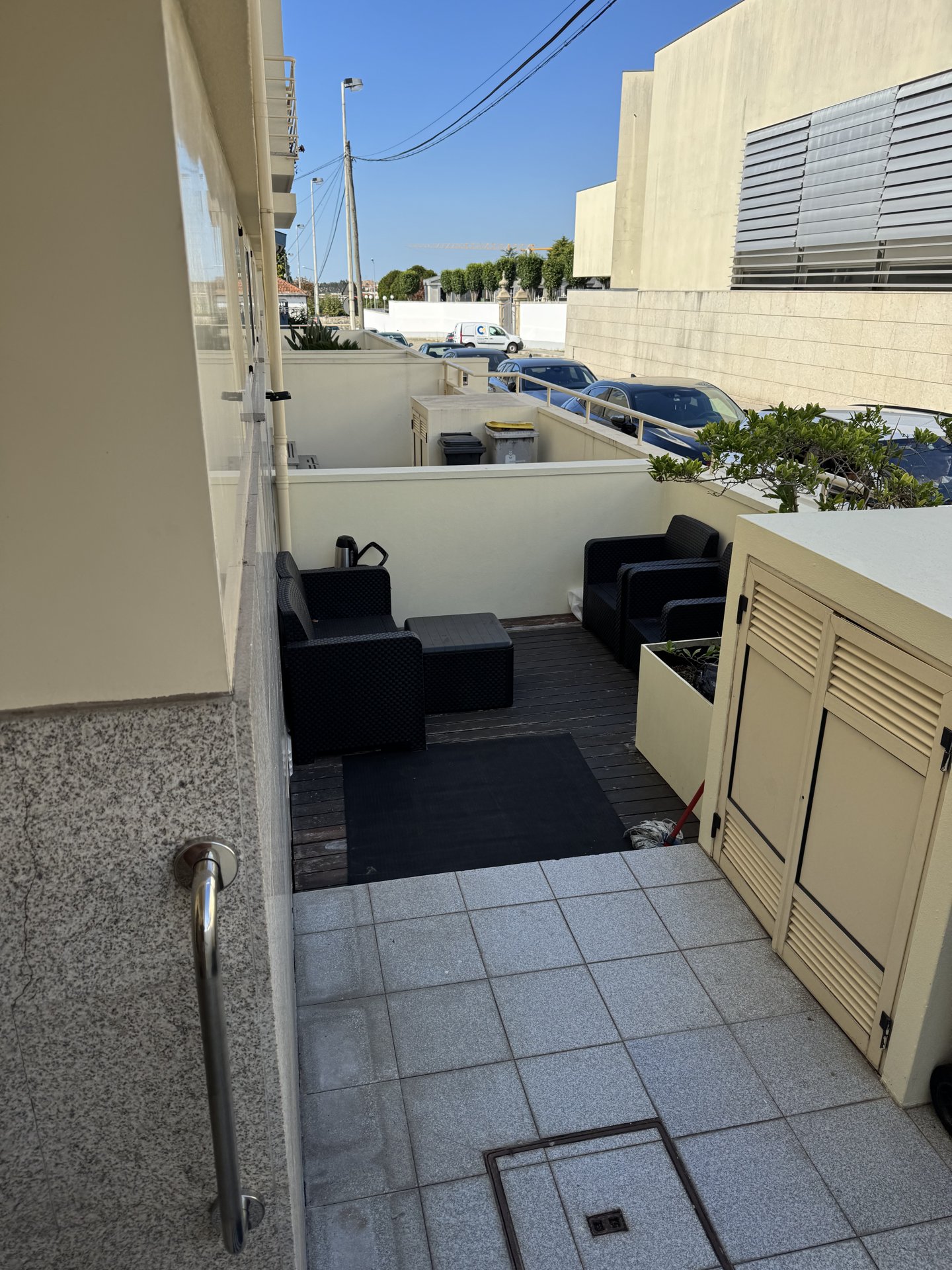 A small terrace by the entrance, with seats outside the door