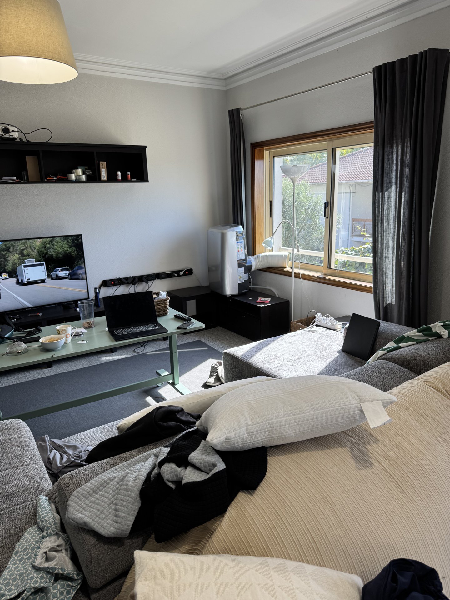 A bedroom with a double bed and a big window